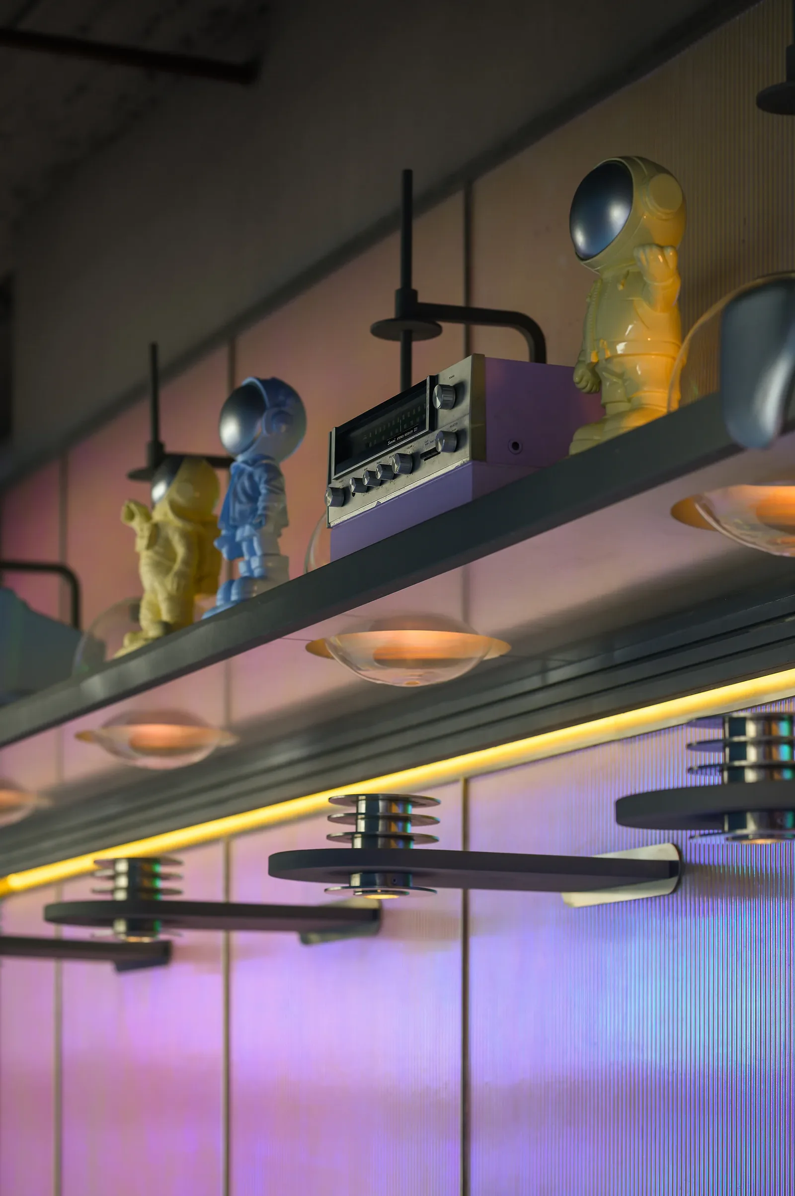 Talkback — Retro-futurist objects on lit shelves