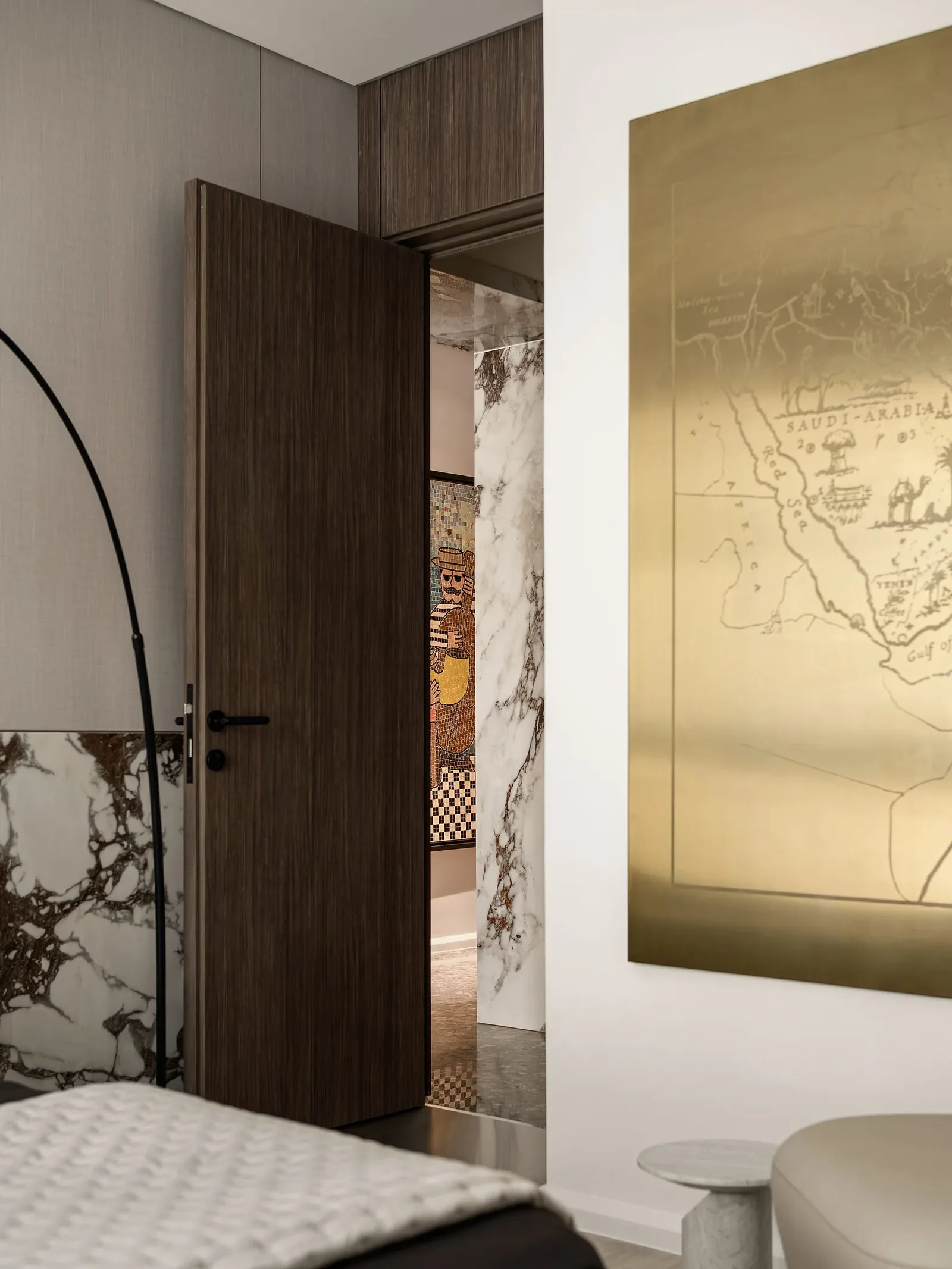 JW Marriott Residences — Bedroom doorway with a gold map artwork