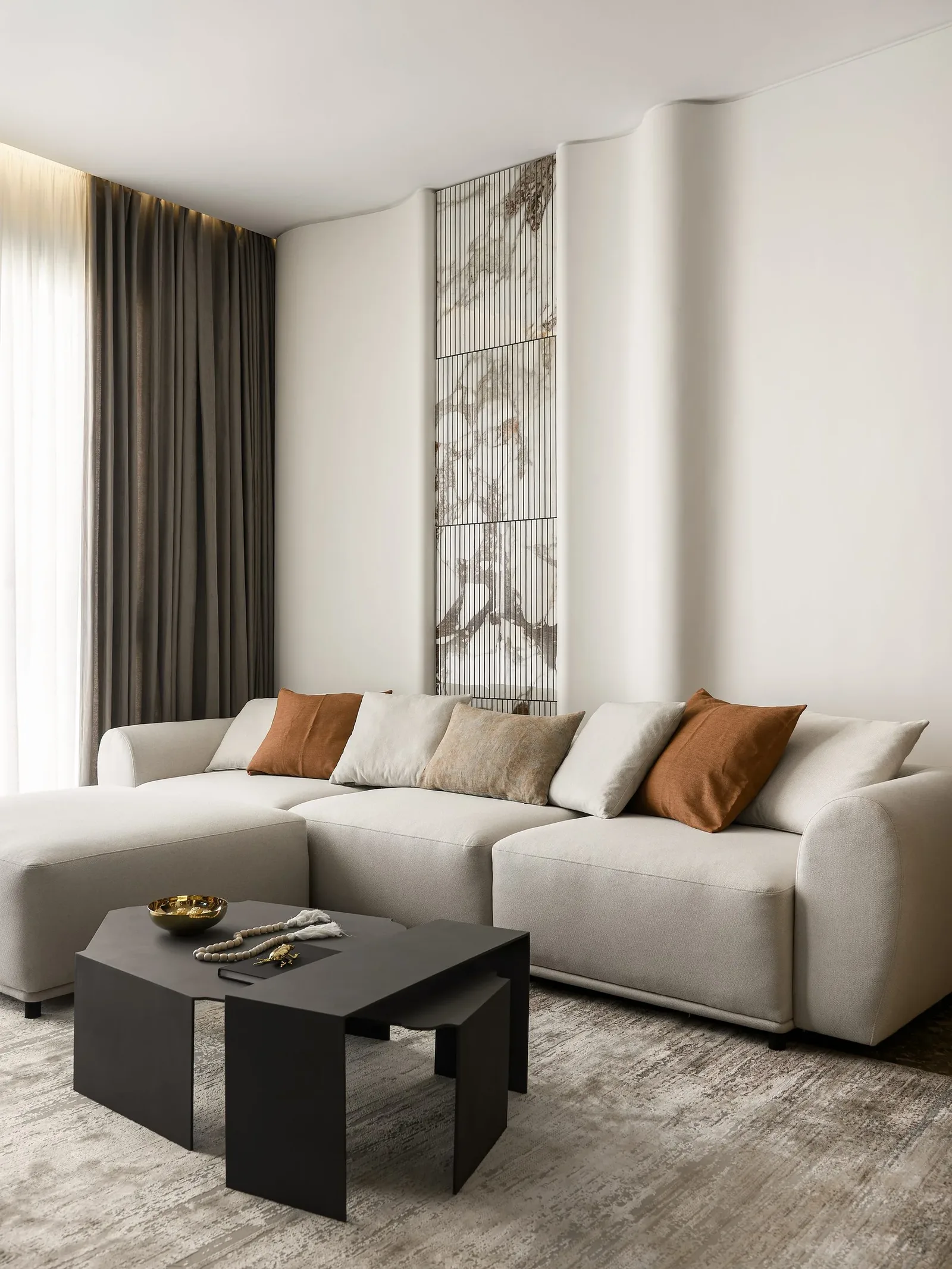 JW Marriott Residences — Sculptural sofa against a fluted wall with marble inlay
