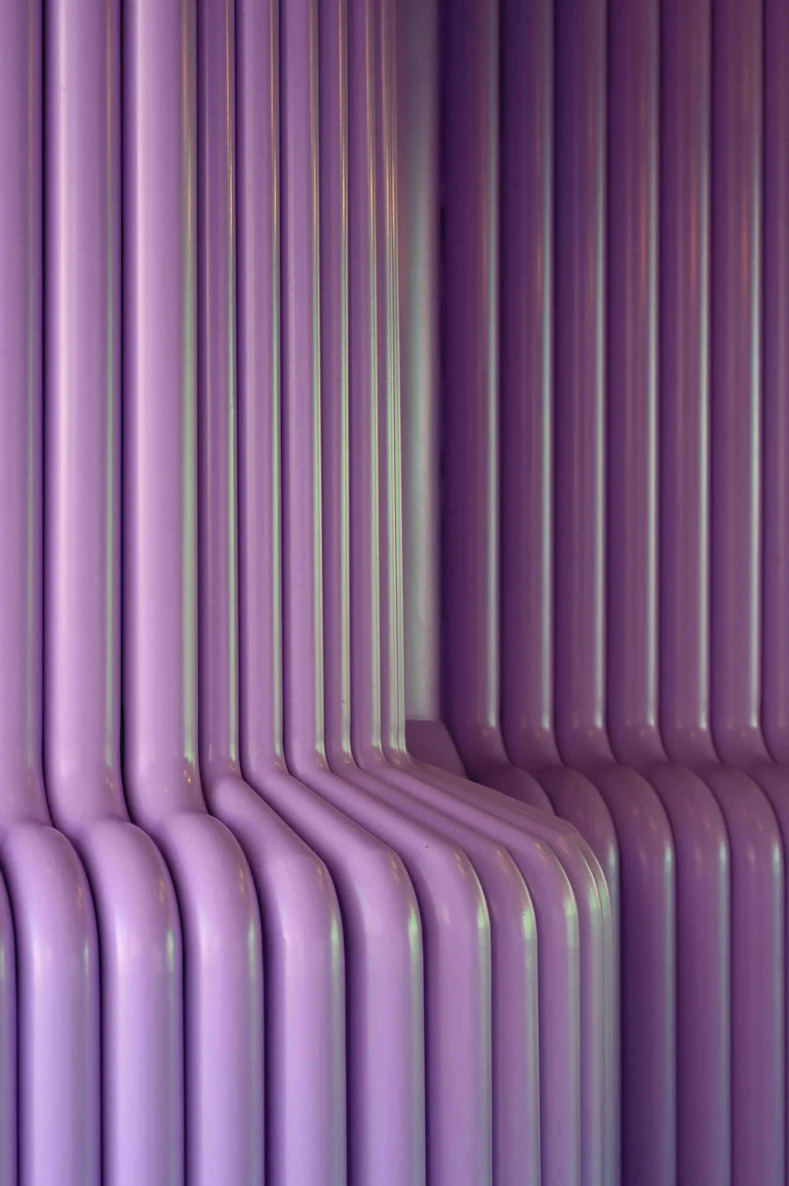 Talkback — Wall clad in glossy purple tubes