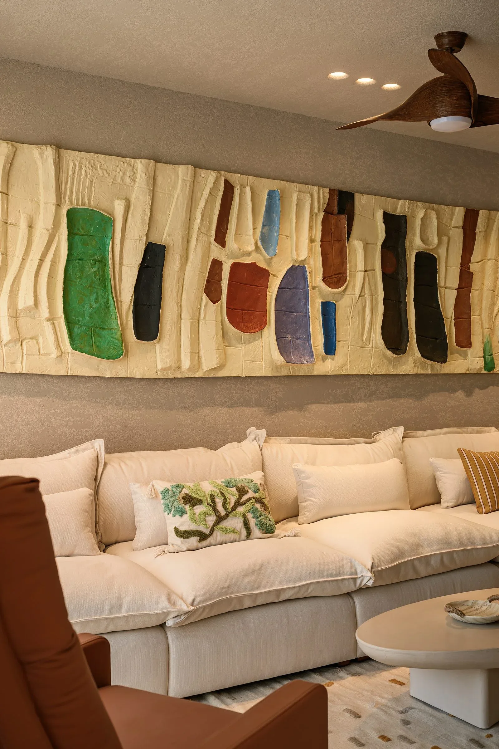 Casa Terrane — Living room beneath a relief artwork