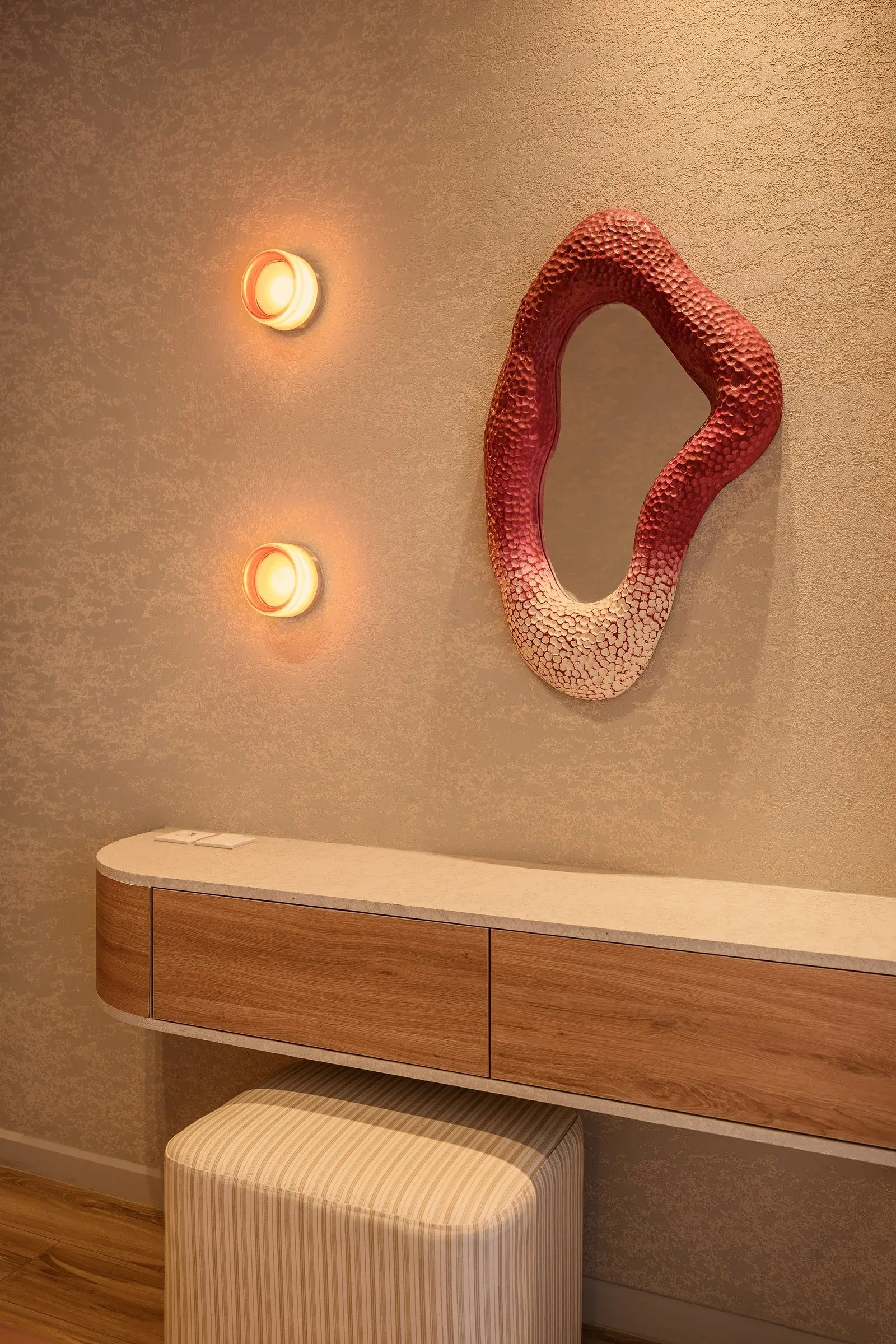 Casa Terrane — Vanity beneath a red sculpted mirror