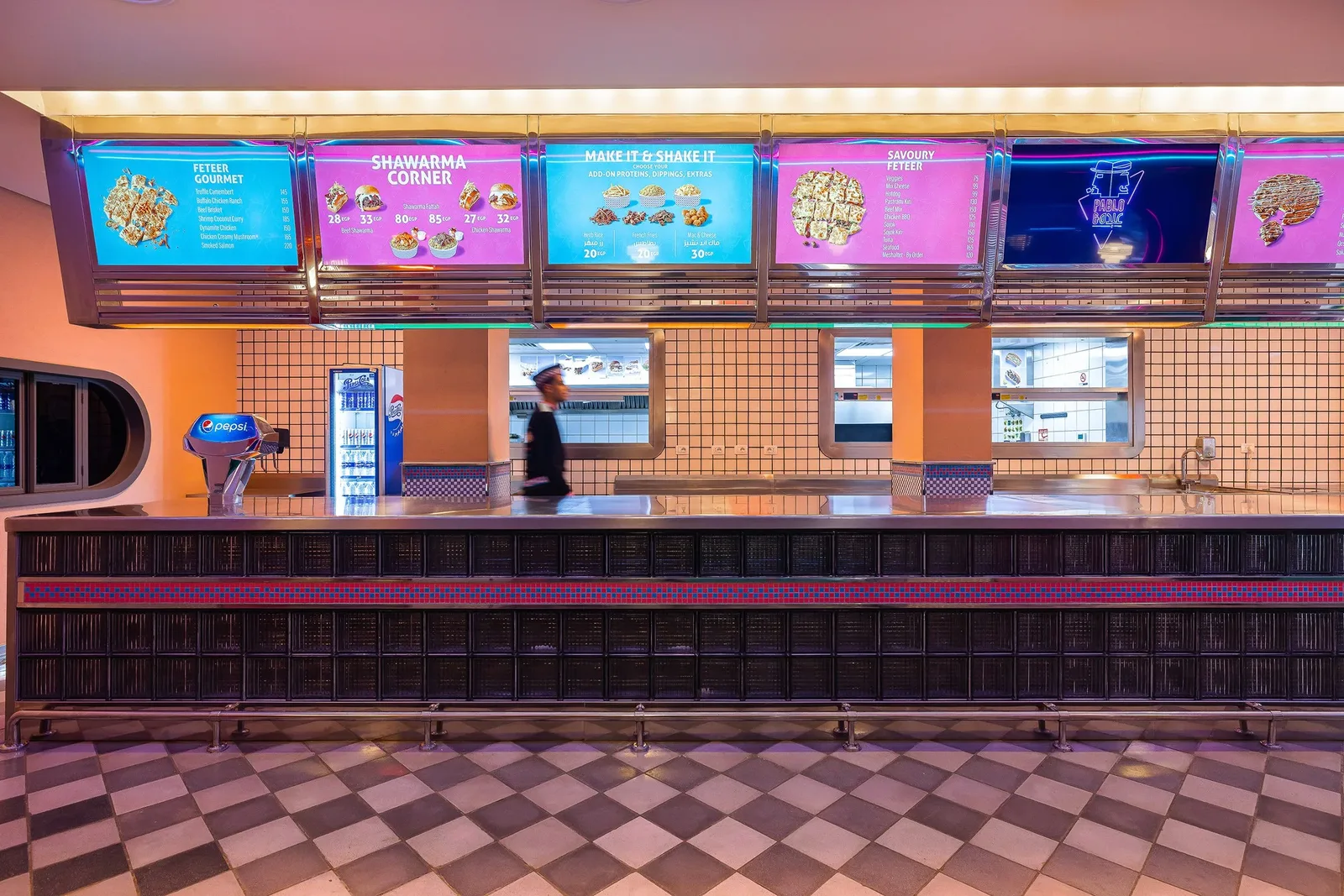 Pablo & Abdo — Stainless counter beneath illuminated menu boards